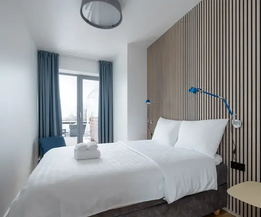 a bed with a lamp and a table