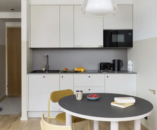 a kitchen with a table and chairs