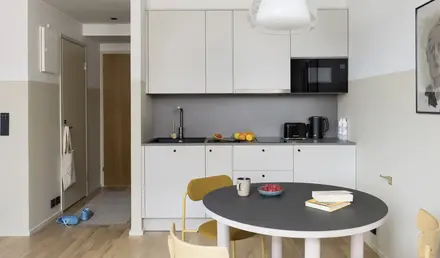 a kitchen with a table and chairs