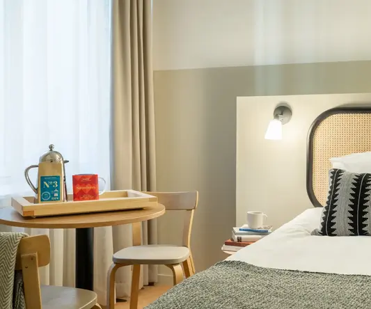 a bed with a tray and a table