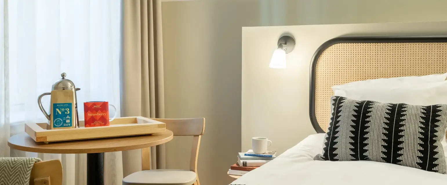 a bed with a tray and a table