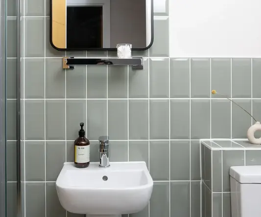 a bathroom with a mirror and sink