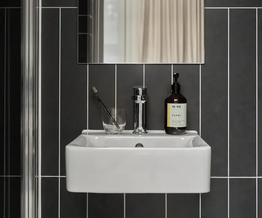 a sink with a mirror and a bottle of liquid on it