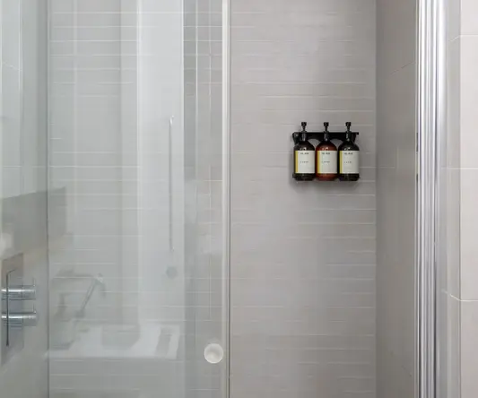 a shower with glass doors and a bathtub