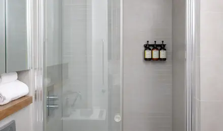 a shower with glass doors and a bathtub