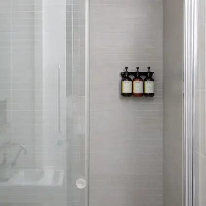 a shower with glass doors and a bathtub