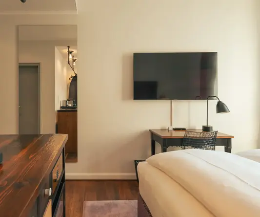 a room with a tv and a bed