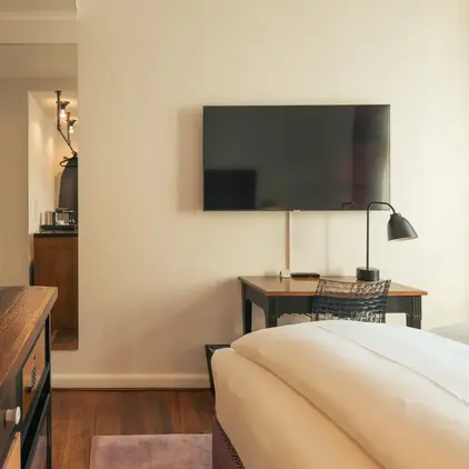 a room with a tv and a bed