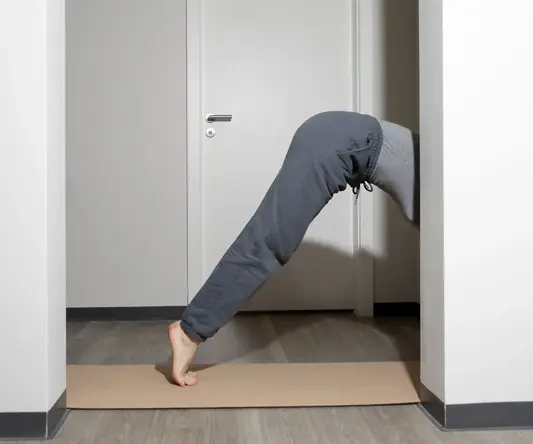 a person bending over in a doorway
