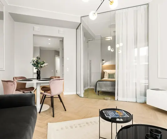 a room with a couch and a table and chairs