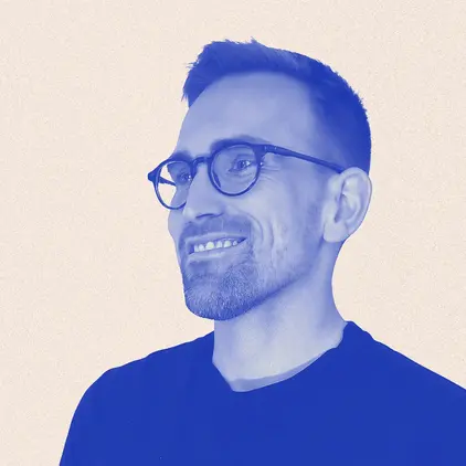 a man wearing glasses and a suit