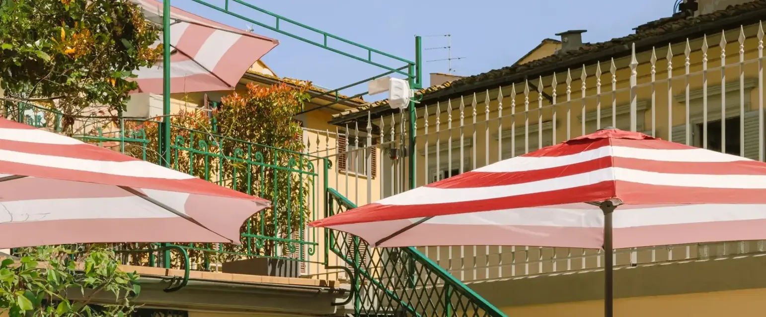 a patio with tables and umbrellas