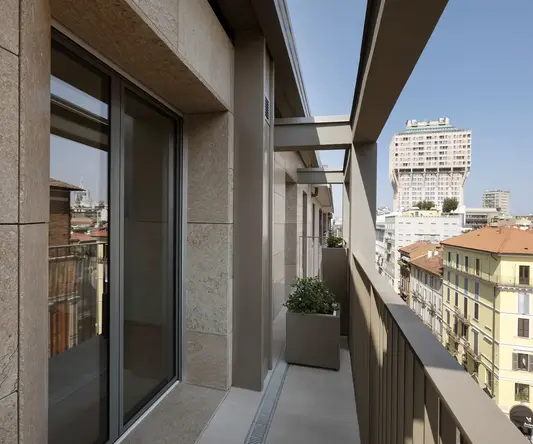a balcony with a planter and a city view