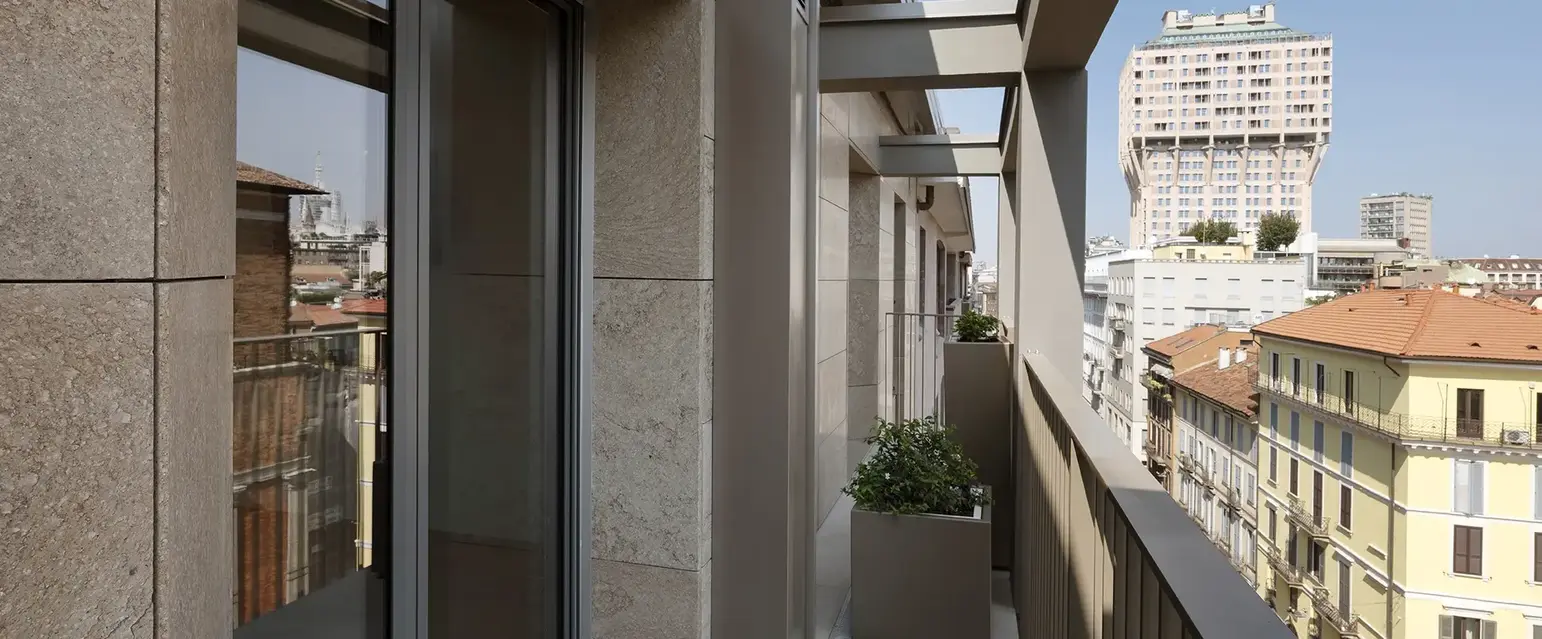 a balcony with a planter and a city view