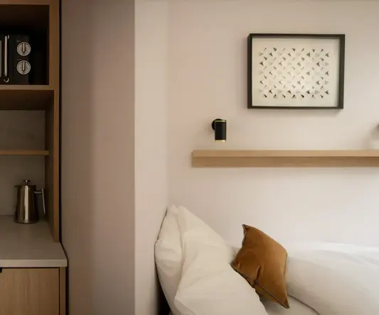 a bed with pillows and a shelf