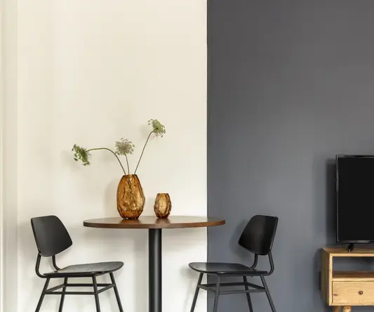 a table with chairs and a television
