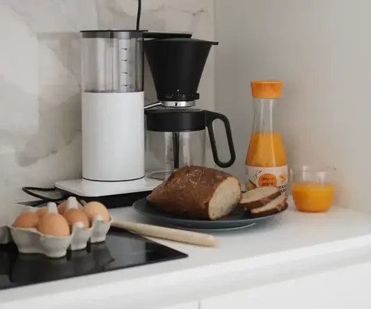 a coffee maker and food on a counter