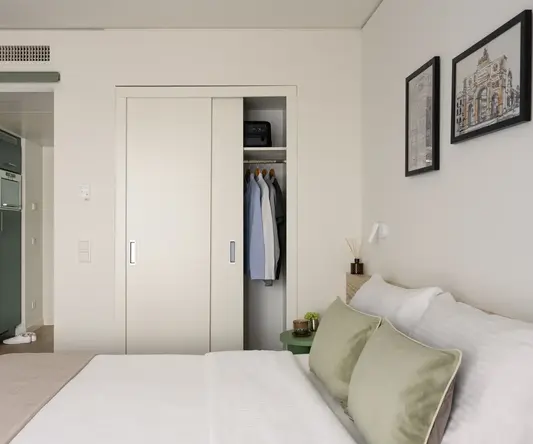 a bedroom with a closet and a bed