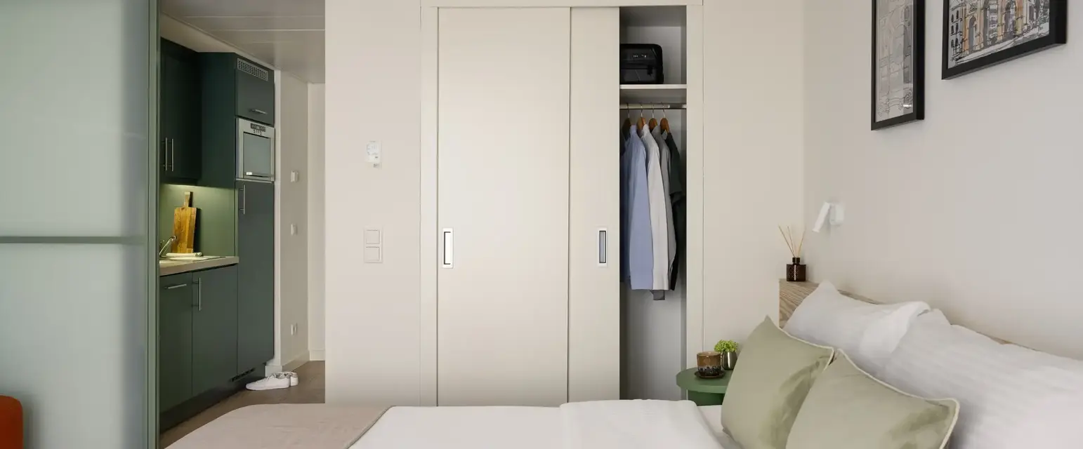 a bedroom with a closet and a bed