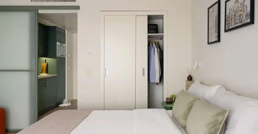 a bedroom with a closet and a bed