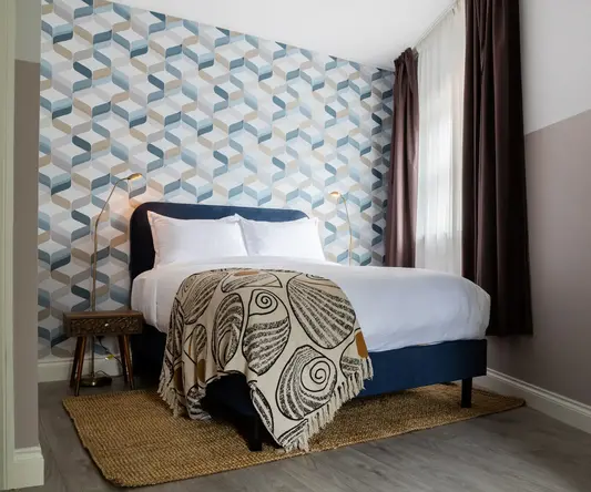 a bed with a blanket in a room