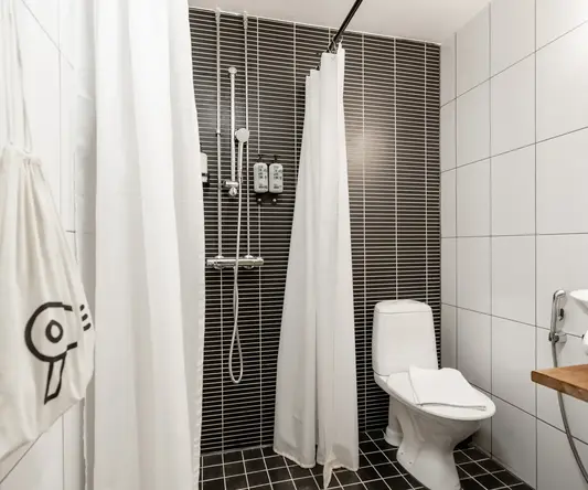 a bathroom with a toilet and shower