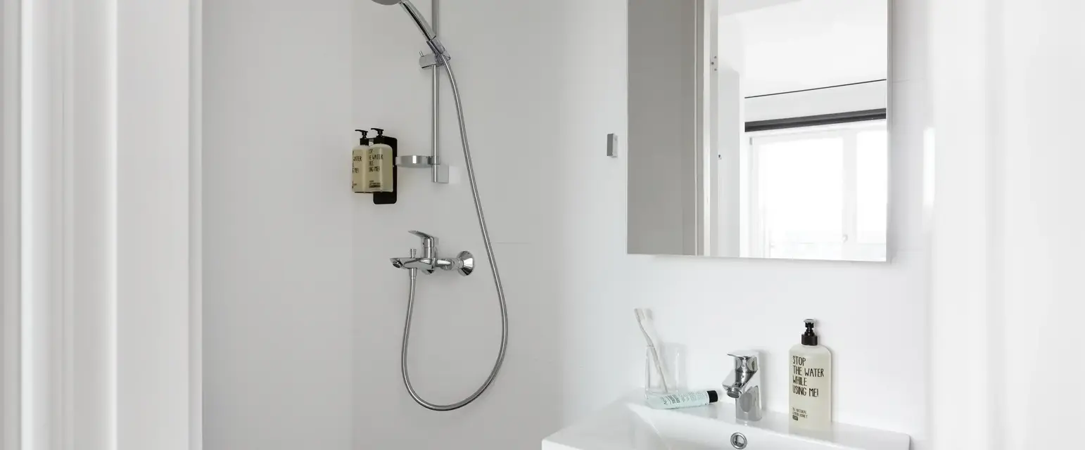 a bathroom with a shower and sink