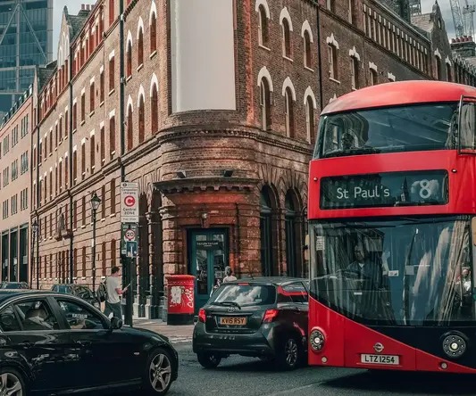 a double decker bus and cars on a street
