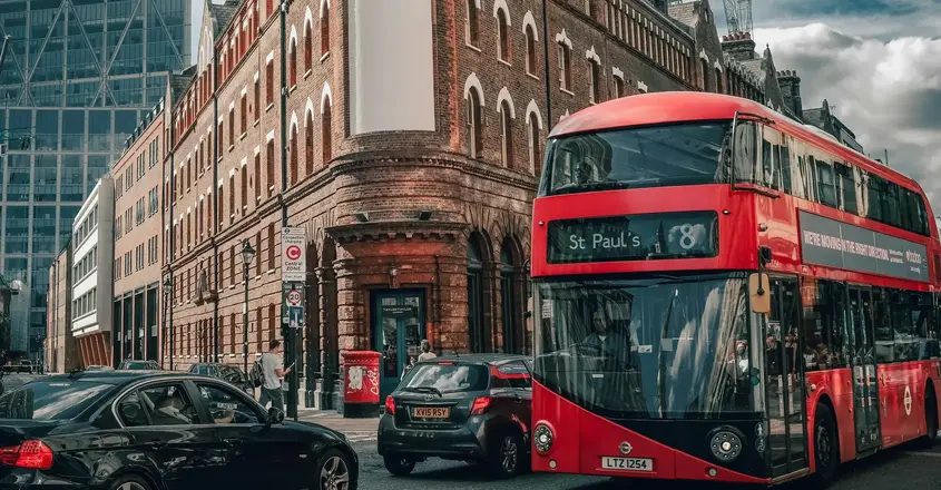 a double decker bus and cars on a street