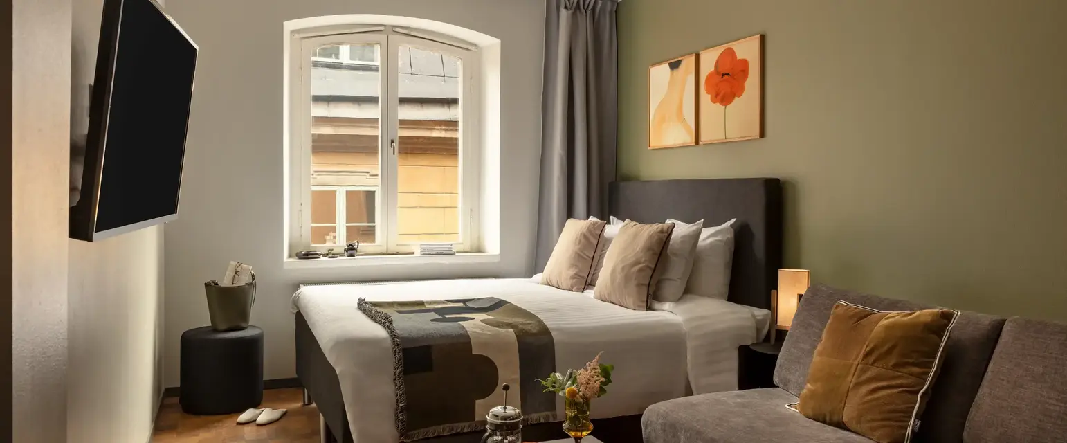 a bedroom with a bed and a television
