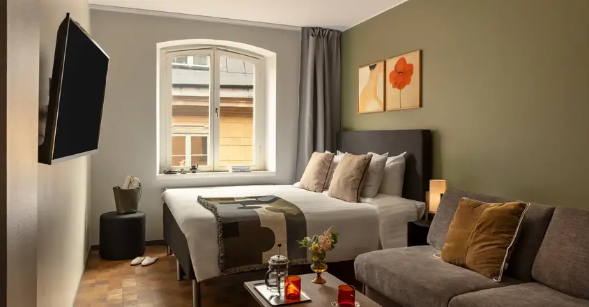 a bedroom with a bed and a television