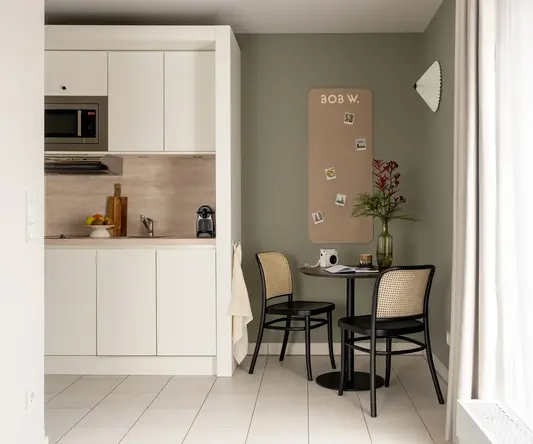 a kitchen with a table and chairs
