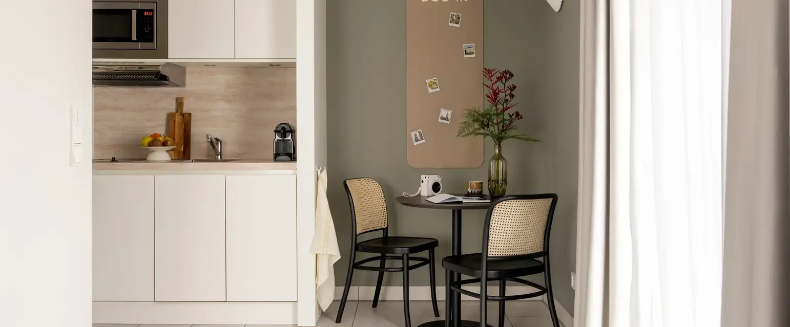 a kitchen with a table and chairs