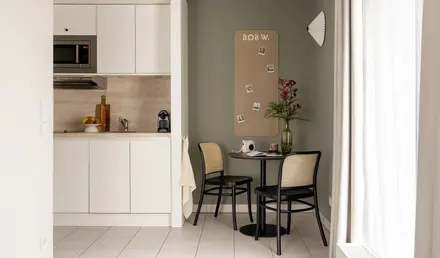 a kitchen with a table and chairs