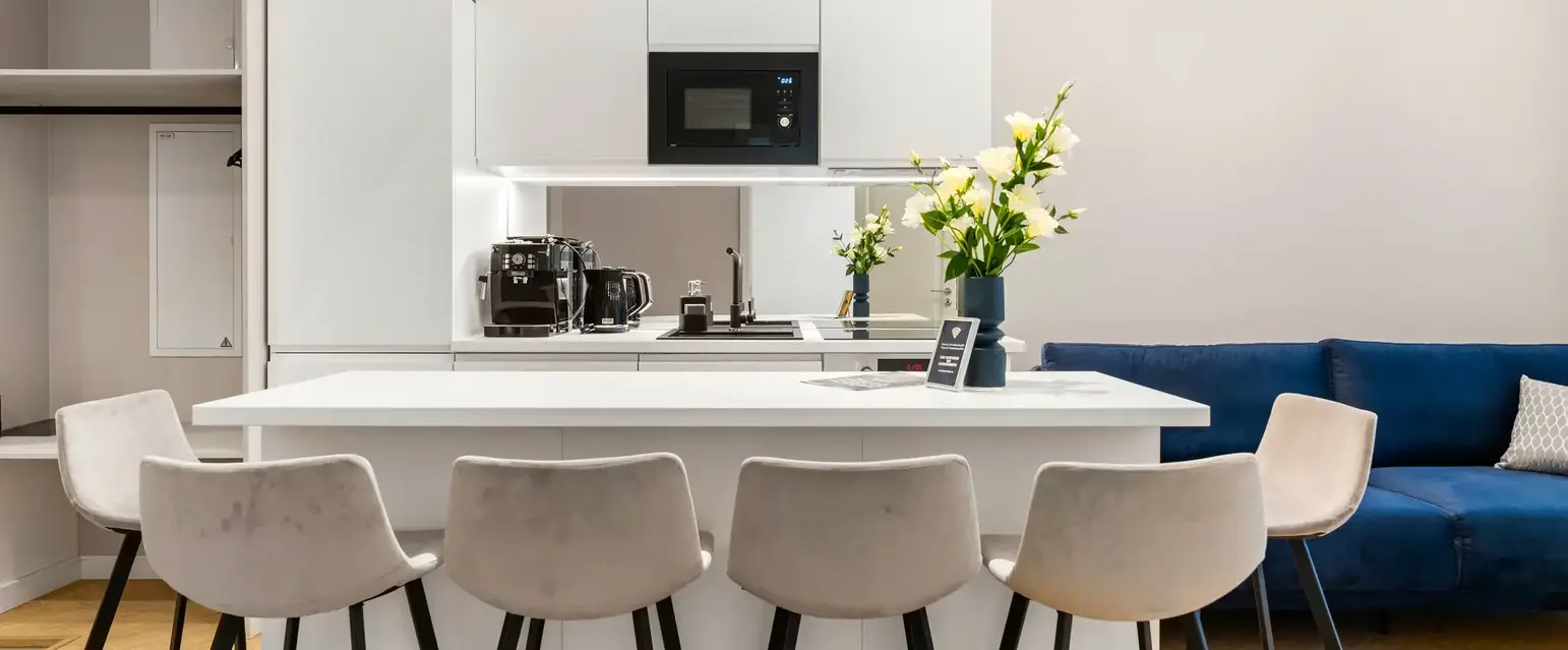 a kitchen with white cabinets and white countertops
