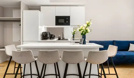 a kitchen with white cabinets and white countertops