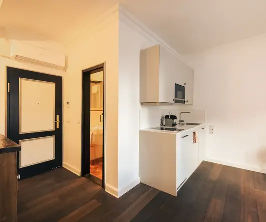 a kitchen with a wood floor and a door