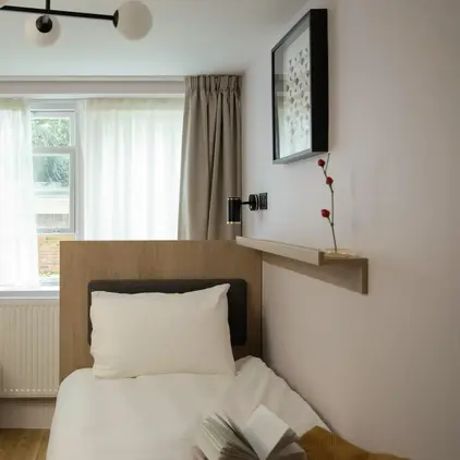 a bed with a book on it