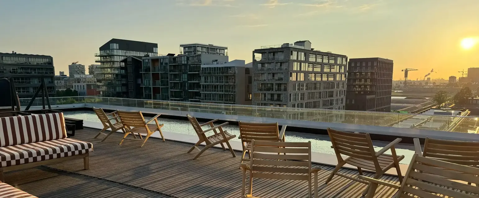 a deck with chairs and a view of a city