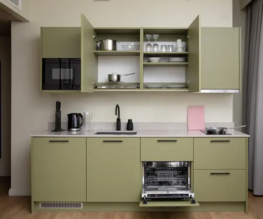 a kitchen with green cabinets and a stove