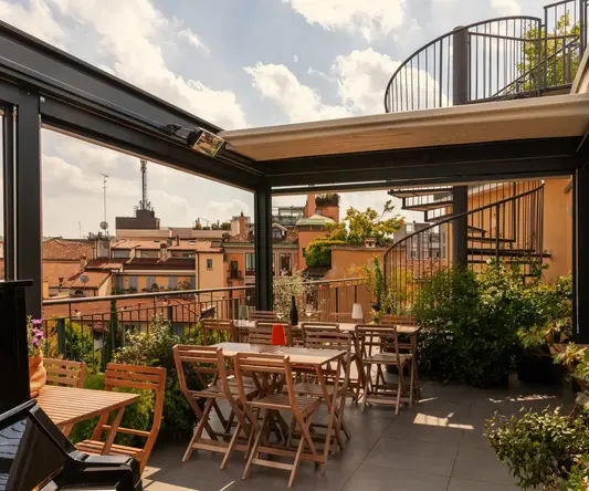 a patio with chairs and tables on a rooftop