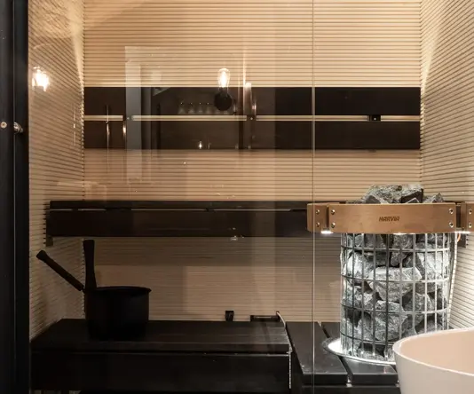 a sauna with a glass wall
