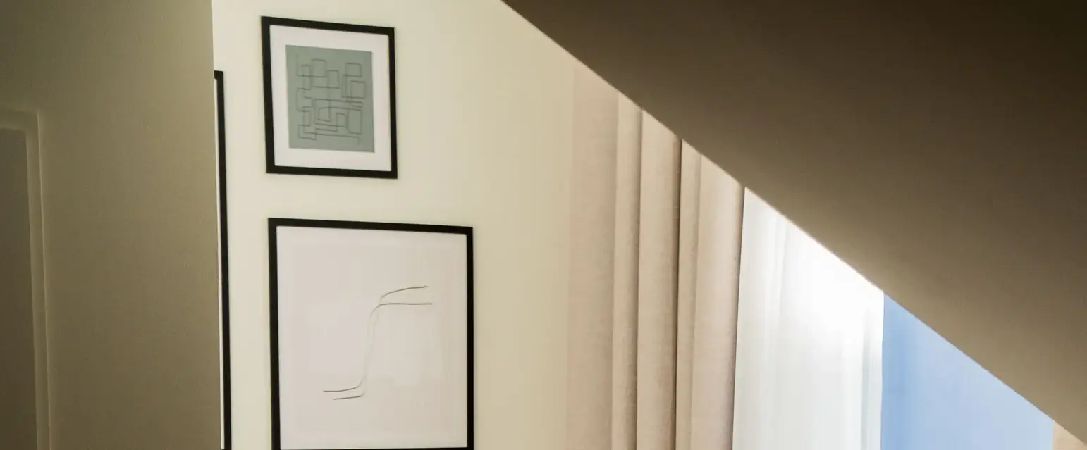 a table with chairs and a vase of flowers