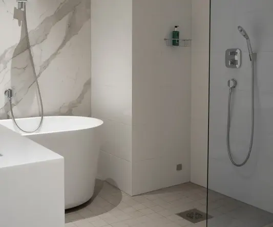 a bathroom with a tub and shower