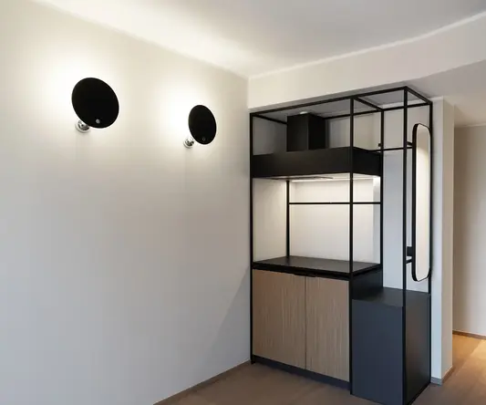 a room with a black and white shelf