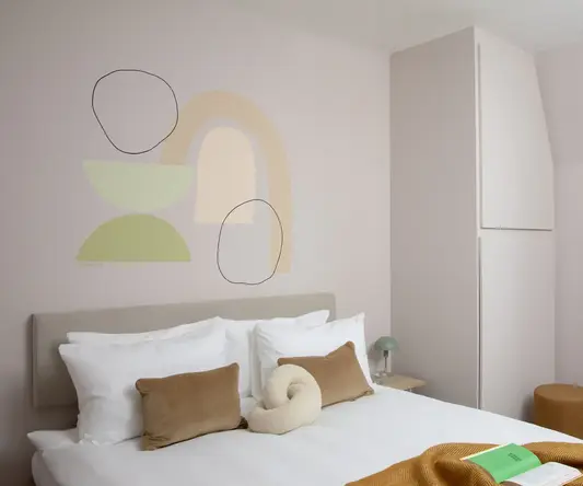 a bed with pillows and a book on it