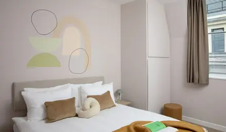 a bed with pillows and a book on it