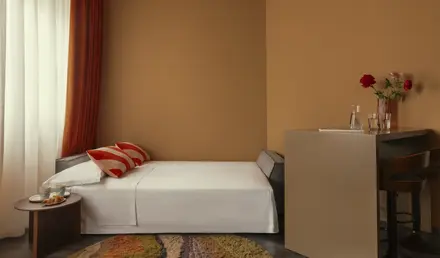 a bed with a red flower in a room