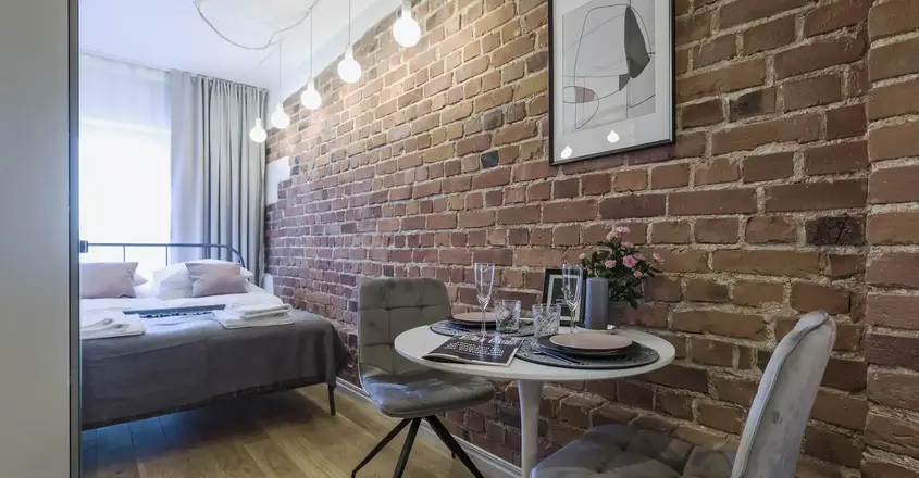 a room with a bed and a table and chairs