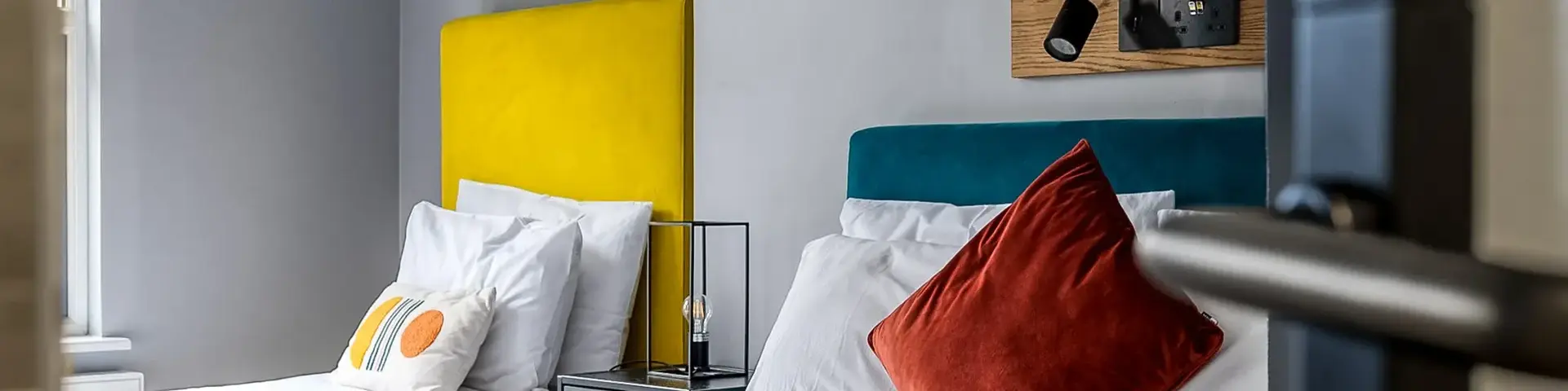 a bed with white sheets and pillows